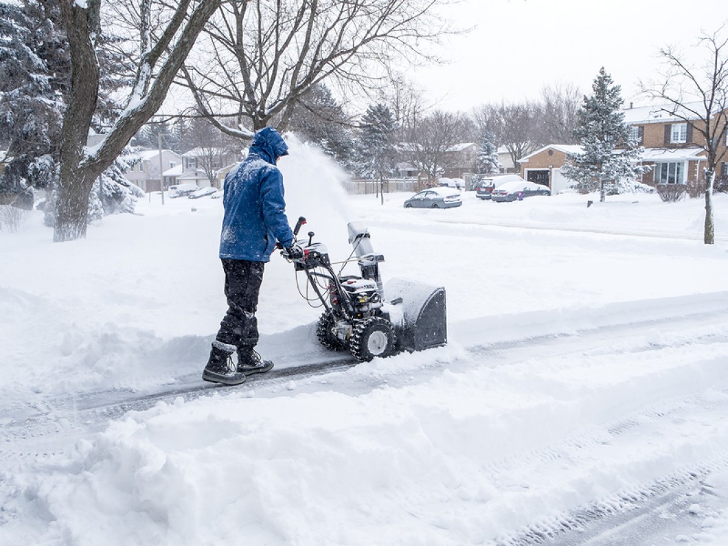 person using snow blower