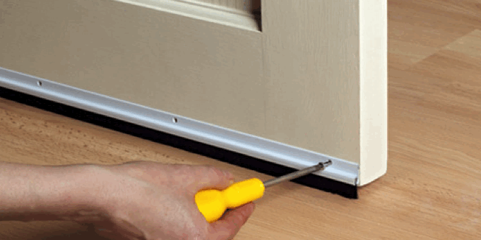 handyman adding door sweep