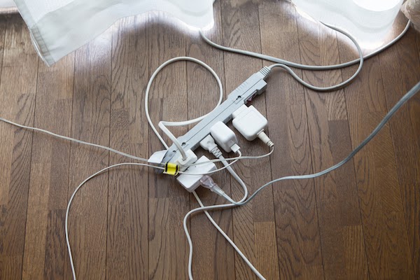 power strip on floor with messy cords