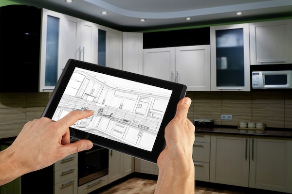 kitchen designer planning kitchen layout on tablet