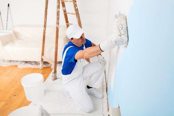 professional painter painting wall