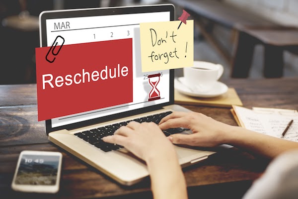 person at computer desk rescheduling appointment 
