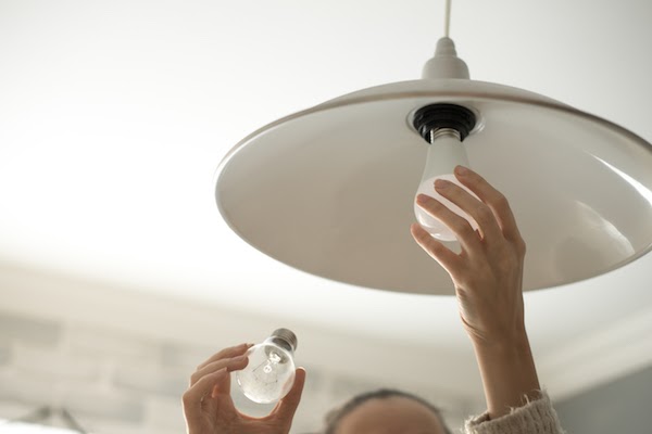 person changing light bulbs to make room brighter