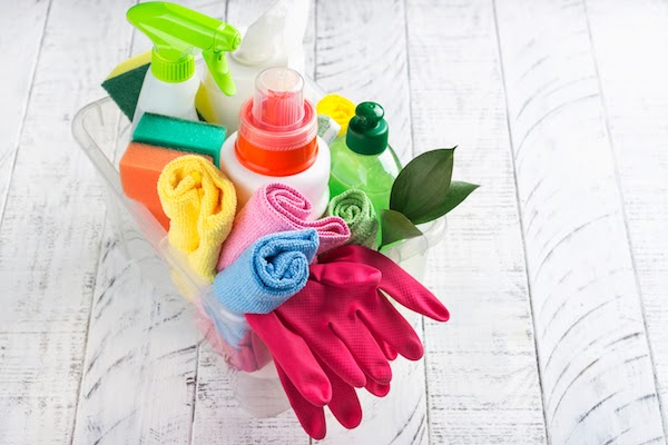 basket of cleaning supplies for a spotless bathroom