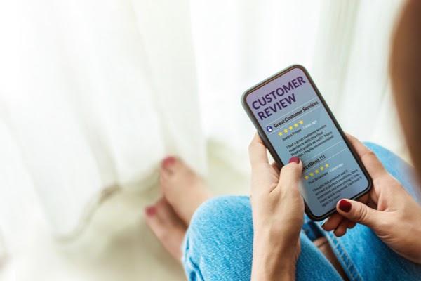 homeowner reading customer reviews on phone