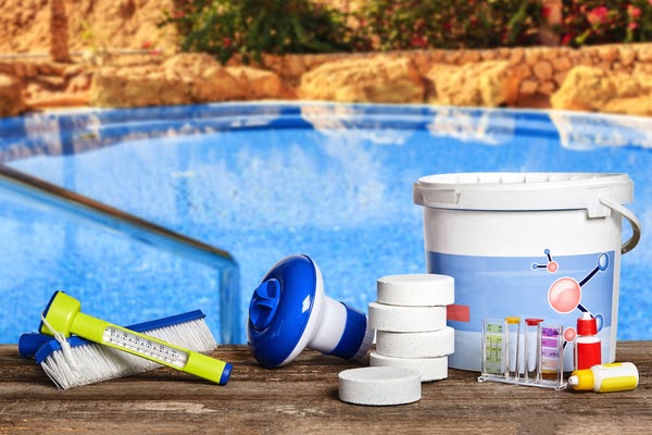 pool cleaning supplies on edge of pool