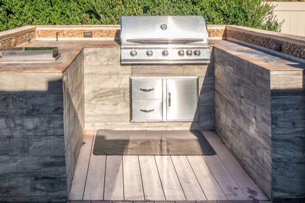 outdoor kitchen construction of counter top islands with cabinets and bbq