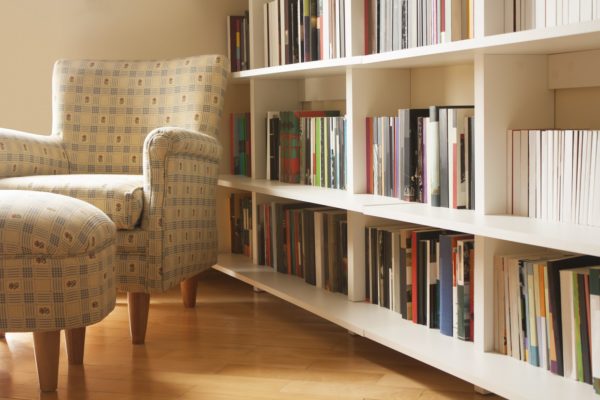 chair next to organized bookshelf