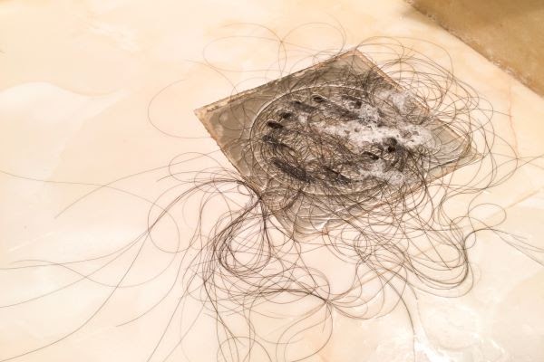 shower drain clogged with hair