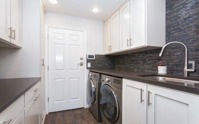 laundry room with counter space and cabinets