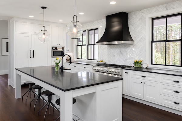 white kitchen with black countertops