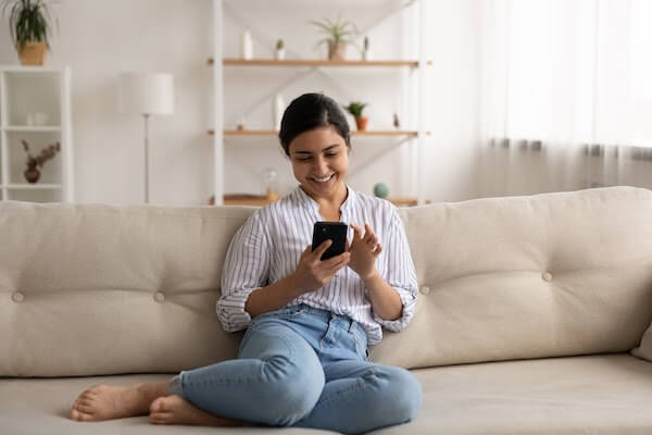 woman on couch using phone