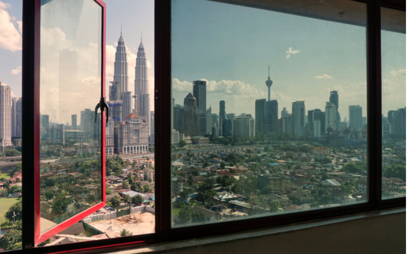 Transparent glass windows look like views of Kuala Lumpur city during sunny day