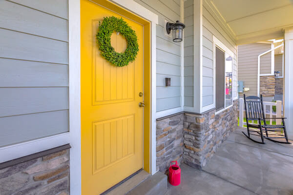 yellow front door with wreath