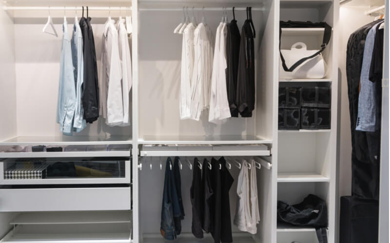  A well-organized closet. All things in their places, in boxes. Capsule wardrobe. Storage system.