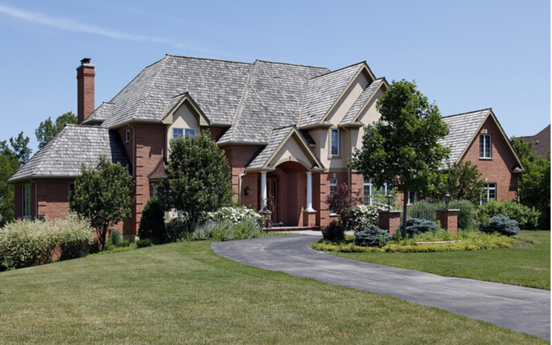 Large brick home with cedar shake roof