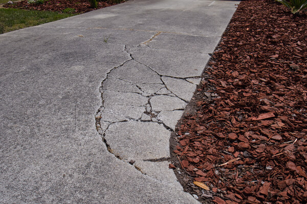 Cracked sunken concrete driveway repair