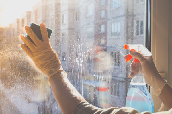 House cleaning. Washing dirty window glass detergent in winter.