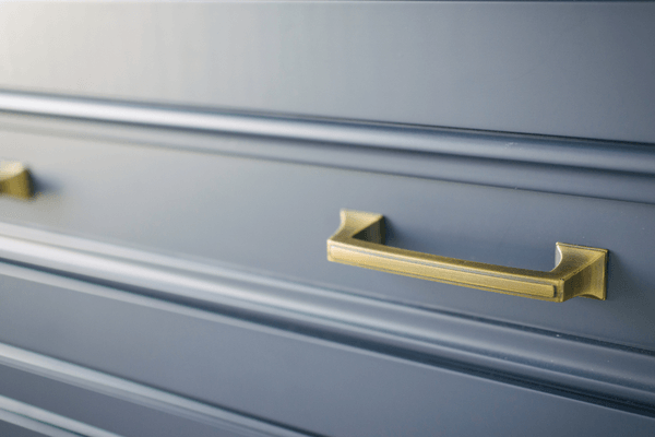 gold hardware on blue cabinets