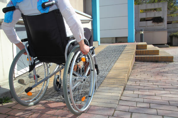 women in wheelchair using accessibility ramp